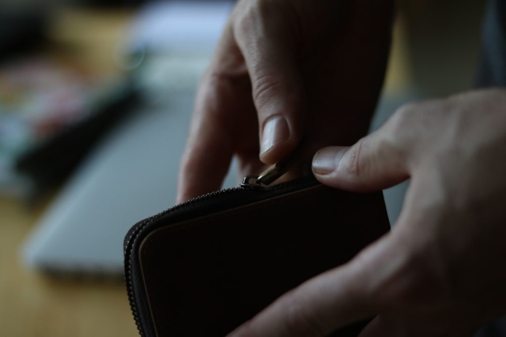 Close-up view of an RV owner's hands holding insurance policy documents and a smartphone, with a calculator showing savings a