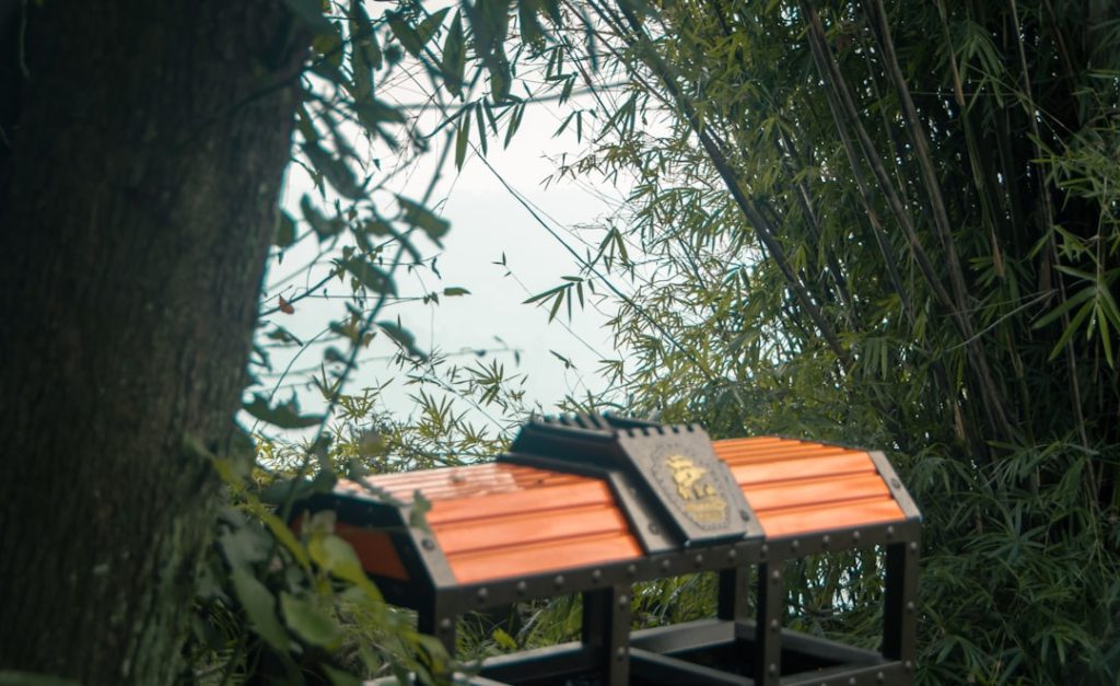 Close-up view of an RV campsite setup showing strategically placed portable bamboo screens and dense potted plants positioned