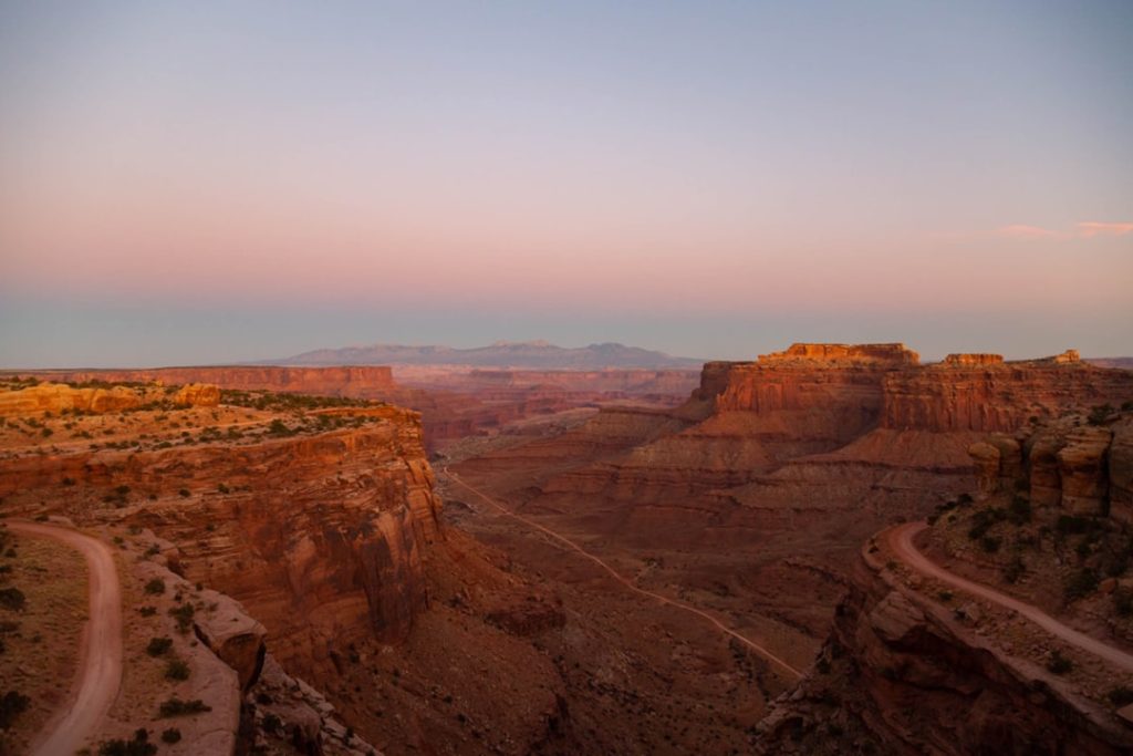 Sunset light illuminating the vast canyons and rock formations at Grand View Point in Canyonlands National Park, Utah